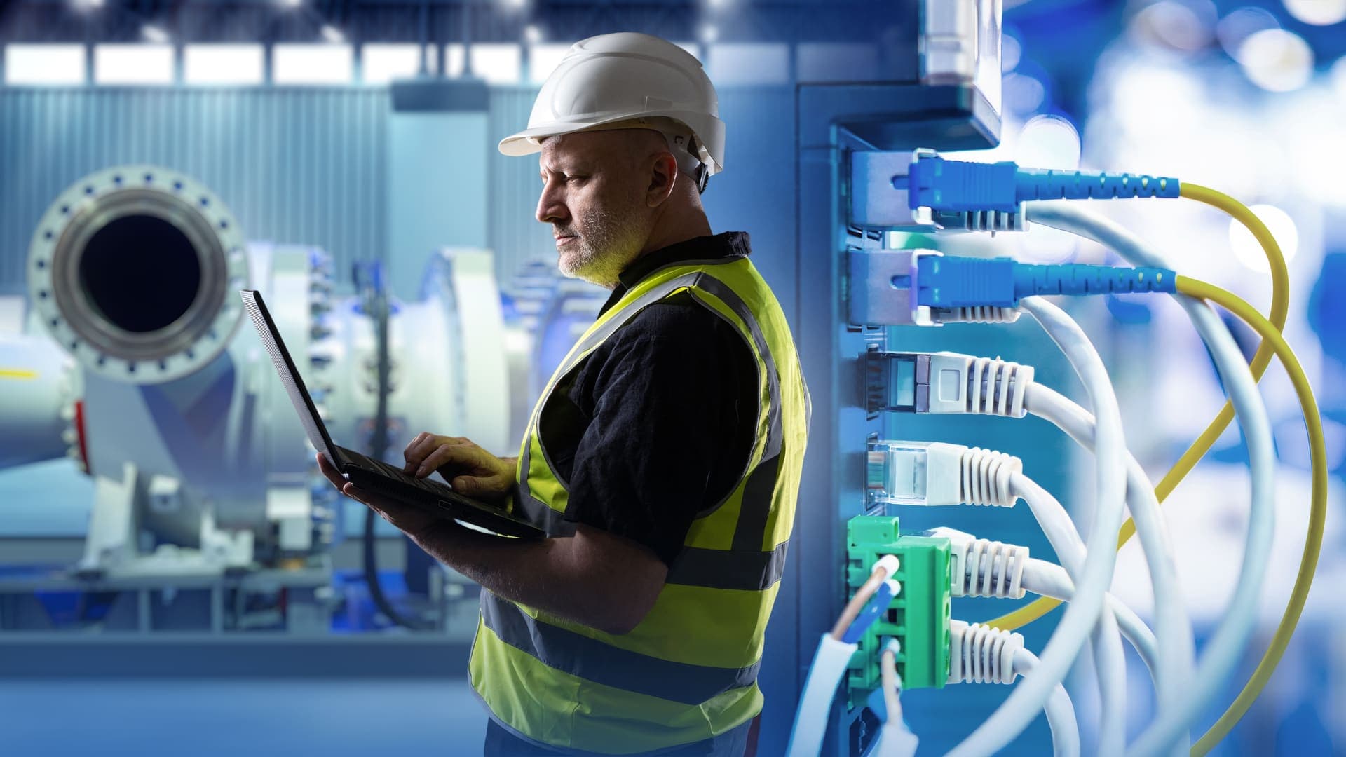 Technician monitors network equipment in an industrial environment