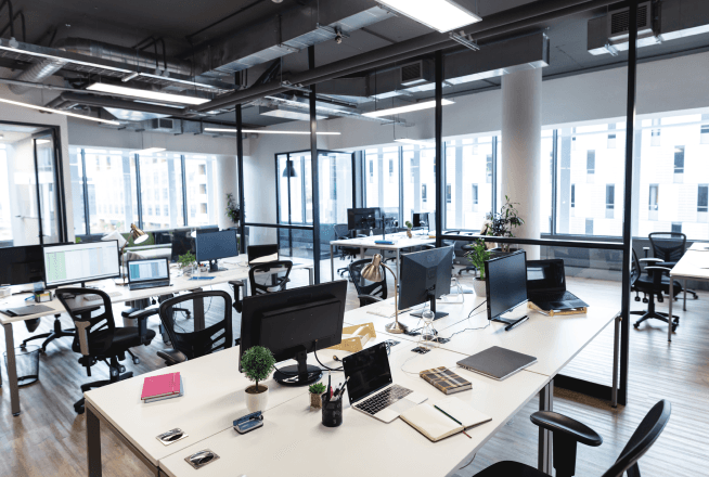 Modern open-plan office with workstations and computers