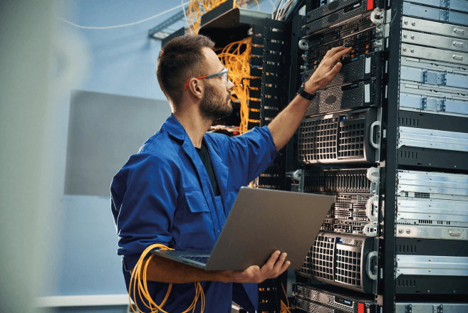 Technician working on network equipment in a server room