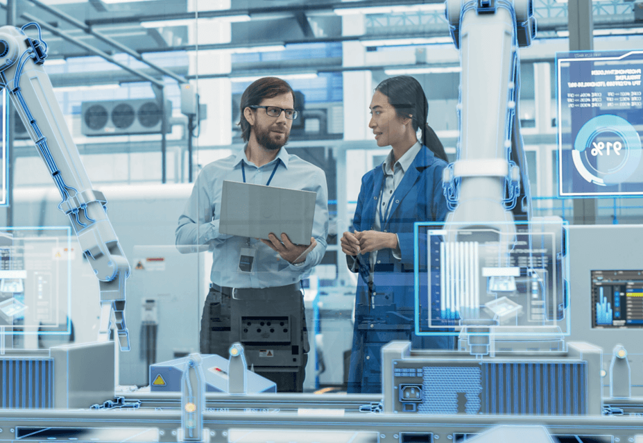 Technicians with laptop in high-tech production environment with robotic arms